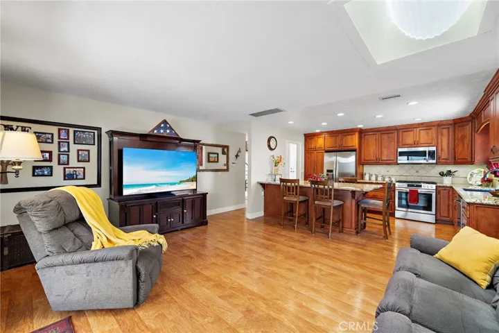 The kitchen opens to the family room with a skylight