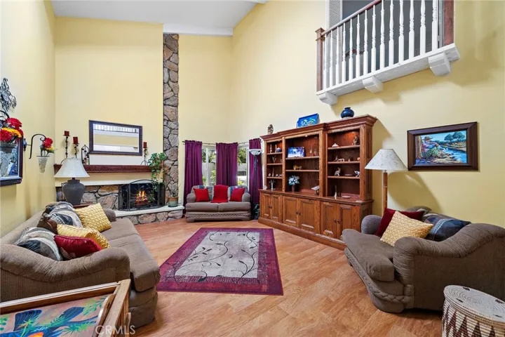 Juliet balcony and floor-to-ceiling stone fireplace in the living room