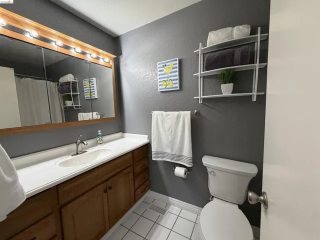 Bathroom featuring a single vanity with wood-finish cabinetry and a white countertop