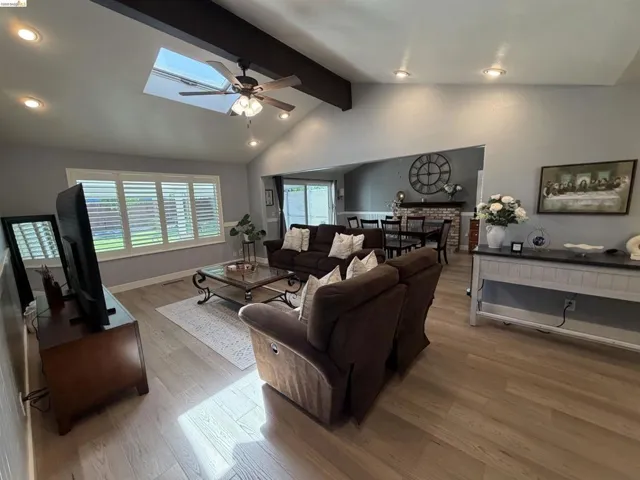 Vaulted ceiling with exposed beam and skylight