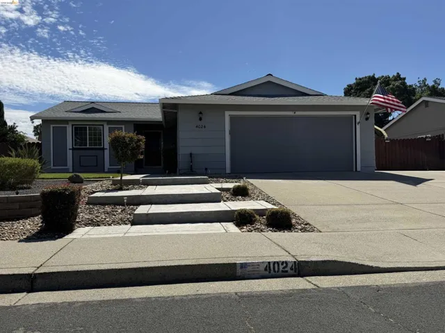 Single-story residence featuring a two-car garage and a paved driveway