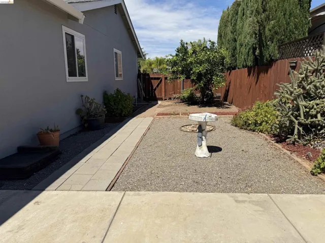 Rear yard with gravel ground cover and perimeter plantings