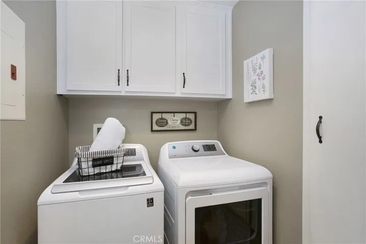 Inside laundry room with shaker style white cabinetry
