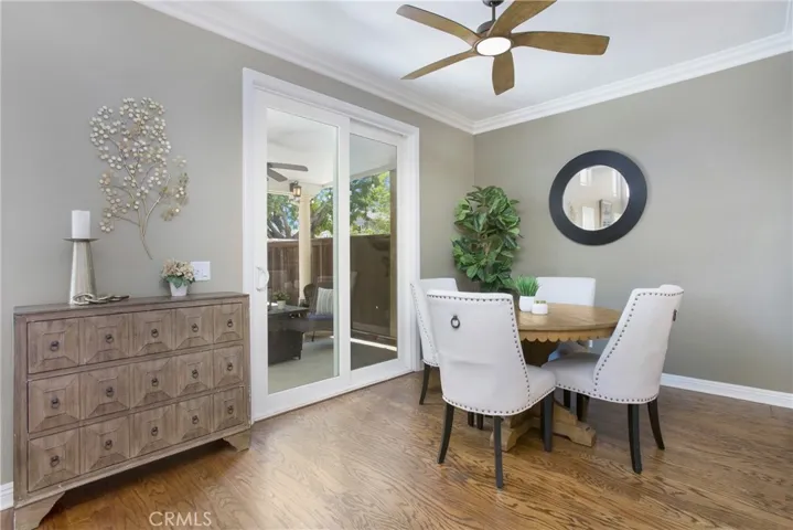 Dining opens to the backyard through the tall sliding doors