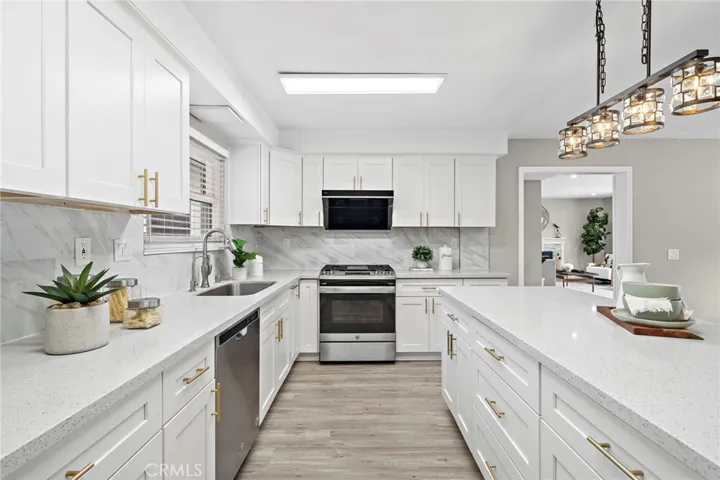 Custom White Shaker Self-Closing Cabinetry with Deep Pots & Pans Drawers, Pull-Outs, and Double Pantry.