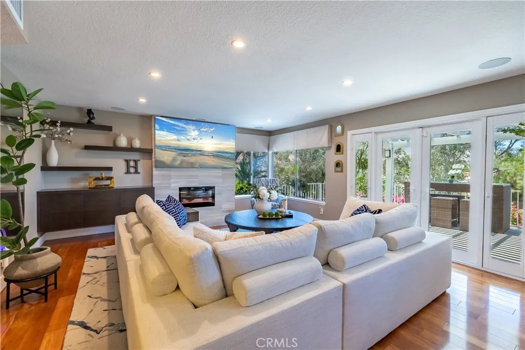 Lovely Family Room with Custom Fireplace. Electric Sun Shades add to your Relaxing Time!