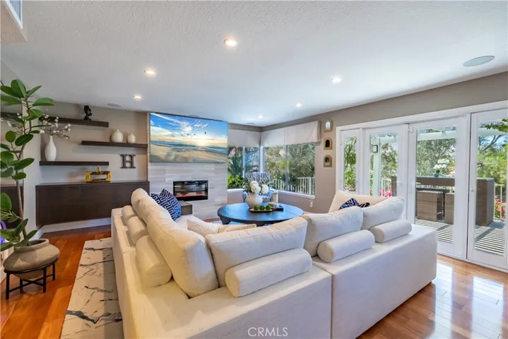 Lovely Family Room with Custom Fireplace. Electric Sun Shades add to your Relaxing Time!