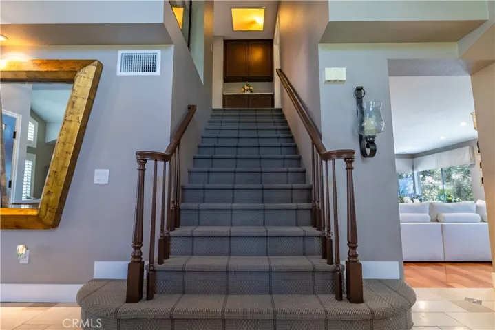 Gorgeous Wide Stairway with Custom Carpet, leads up to the 3 bedrooms upstairs.
