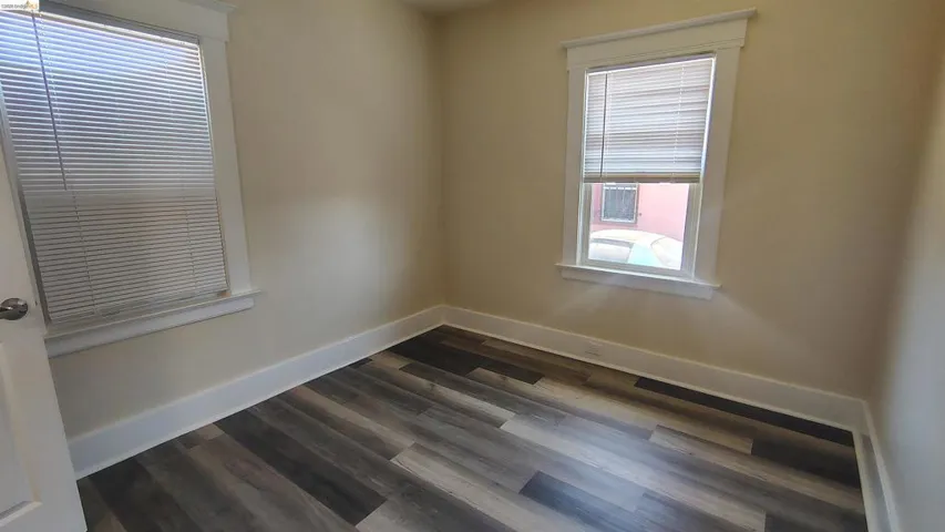 Neutral wall tones complemented by wood-finish flooring