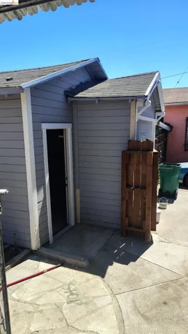 Gray siding exterior with white trim and a gabled roofline