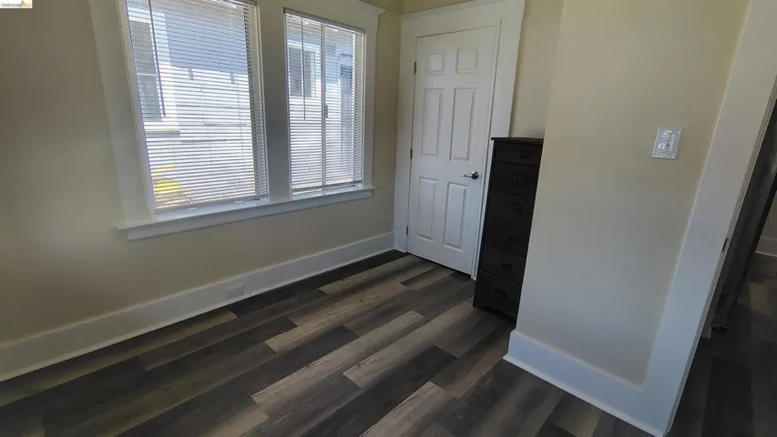 Light-colored walls complementing multi-toned wood-finish flooring
