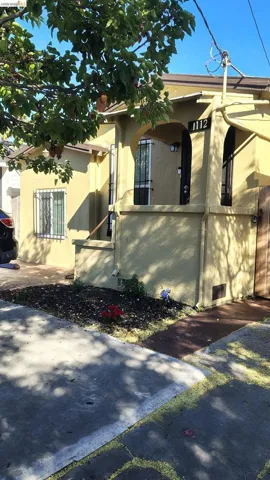 Stucco exterior with arched entryways and window grilles