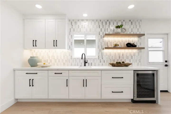 Wet Bar Area of Kitchen with Wine Fridge and Floating Illuminated Shelves