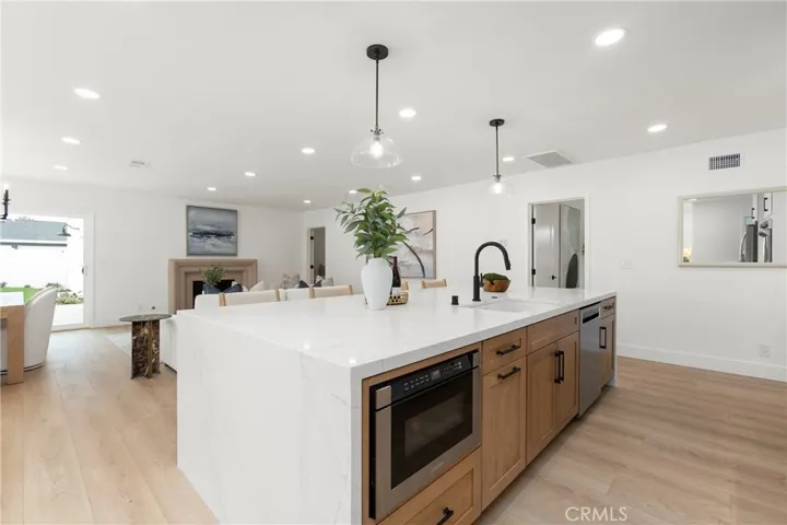 Massive Waterfall Island with Sink and Under-Counter Built-in Microwave