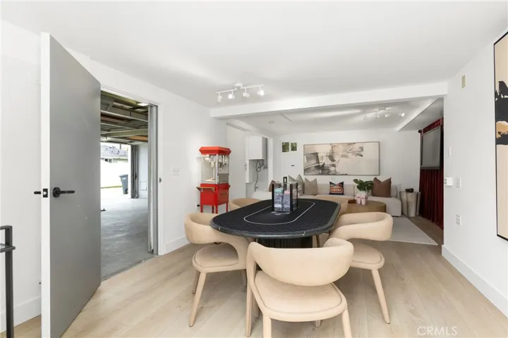 Original Photo- Flex Space/Bonus Room off of Garage - Sliding Wall and a Separate Door to Garage are OPEN to Garage in photo (Potential ADU?)