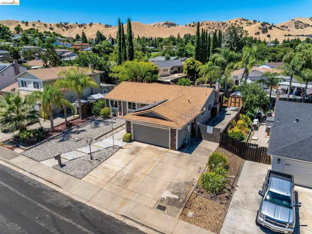 Contemporary residence featuring a two-car garage, concrete driveway, and a low-maintenance front yard with gravel landscaping
