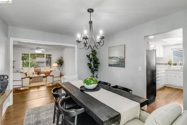 Dining area featuring a dark-finish chandelier and wood-finish flooring