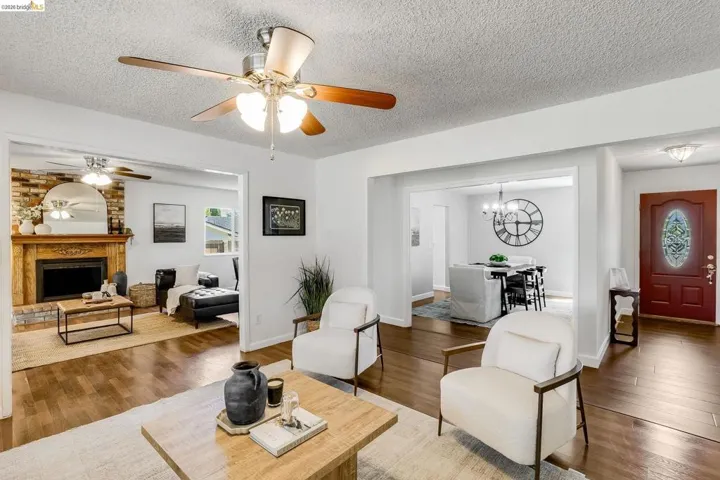 Open concept living area featuring wood-finish flooring