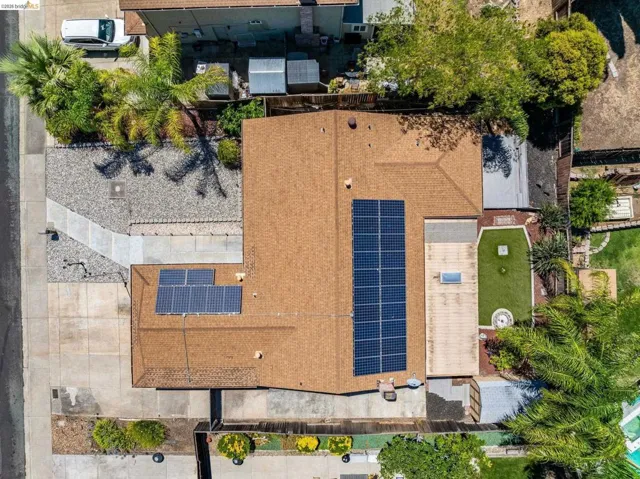 Brown shingle roof with multiple solar panel arrays