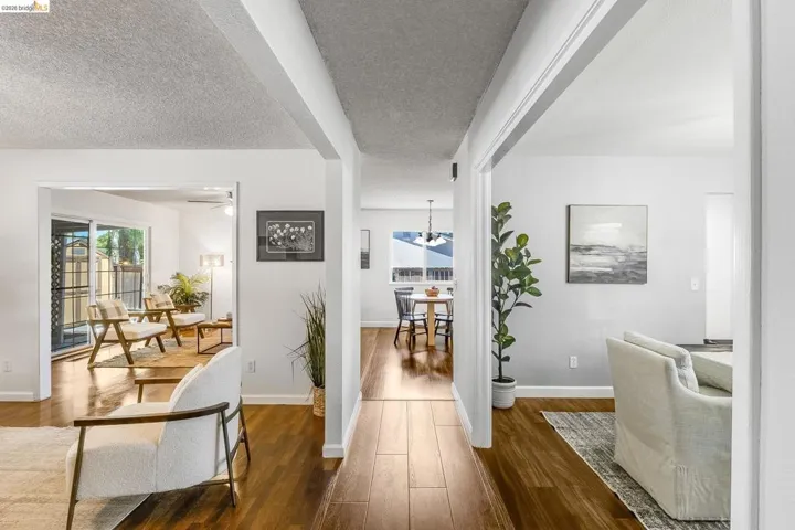 Hallway featuring wood-finish flooring, white walls, and recessed lighting