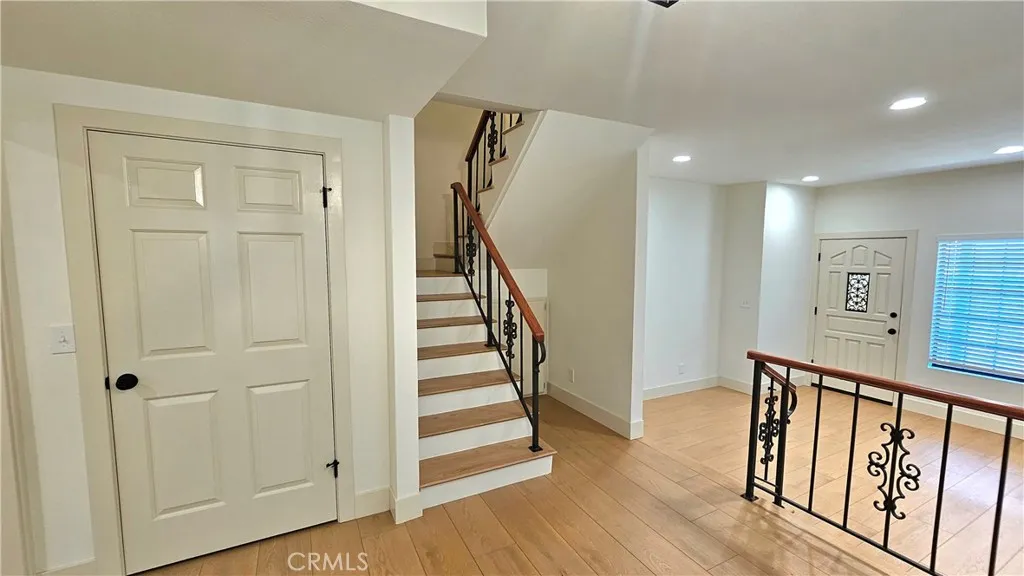 View of living room and stairs to bedrooms from dining room/den