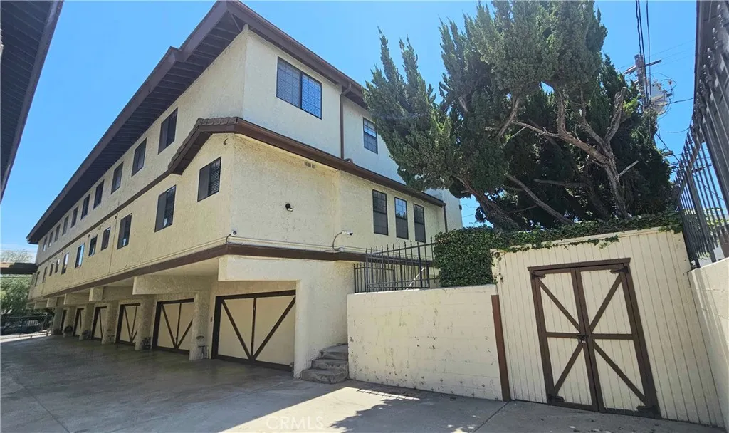 Driveway - Unit F garage at end, steps up to grassy area