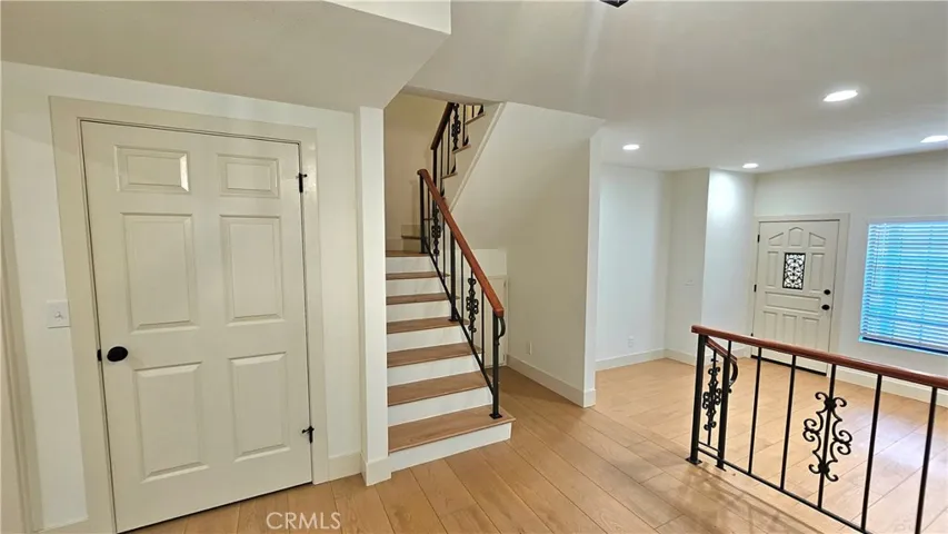 View of living room and stairs to bedrooms from dining room/den