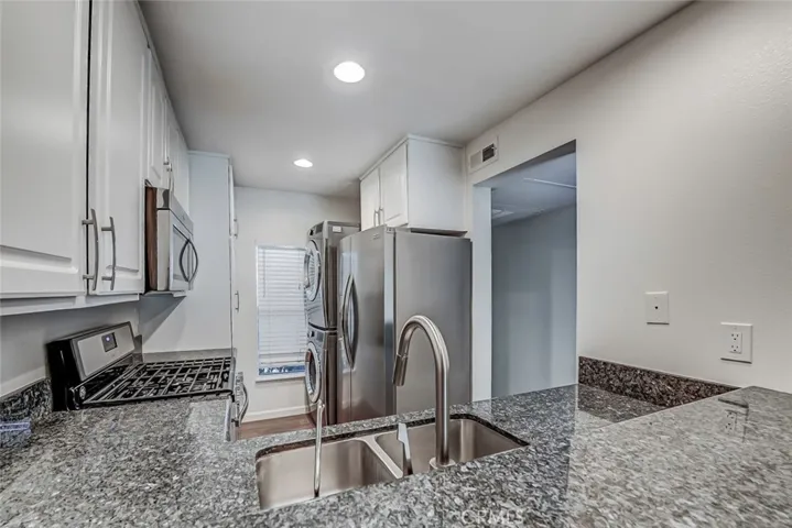 Kitchen with stackable washer and dryer