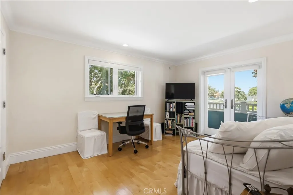 Guest bedroom on second level with doors to balcony. Guest bedroom on second level with doors to balcony.