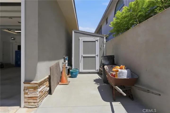 Side of garage with useful storage shed.