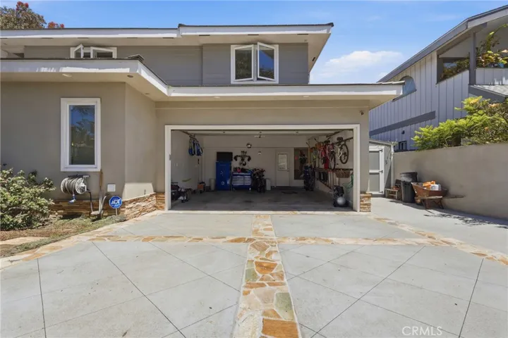 Park multiple vehicles off-street with the 2-car garage and driveway behind a rolling gate.