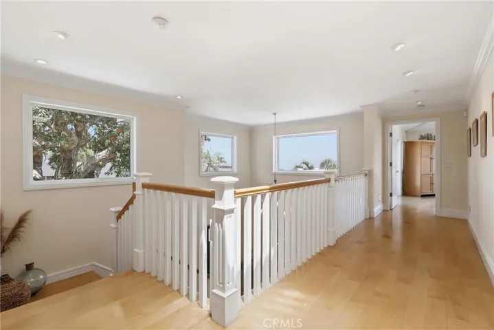 Bright and open upstairs hallway leading to primary suite.