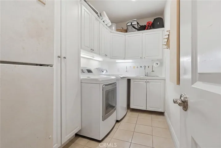 Laundry room on main level with sink and lots of storage.