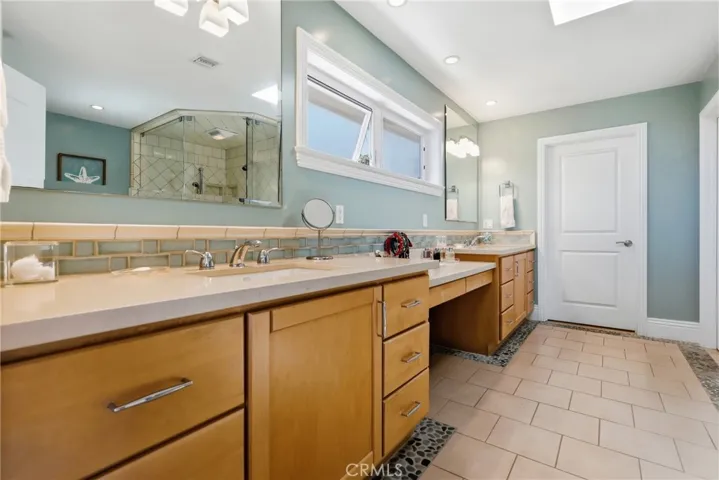 Skylight and upper windows keep the primary bath bright and fresh!