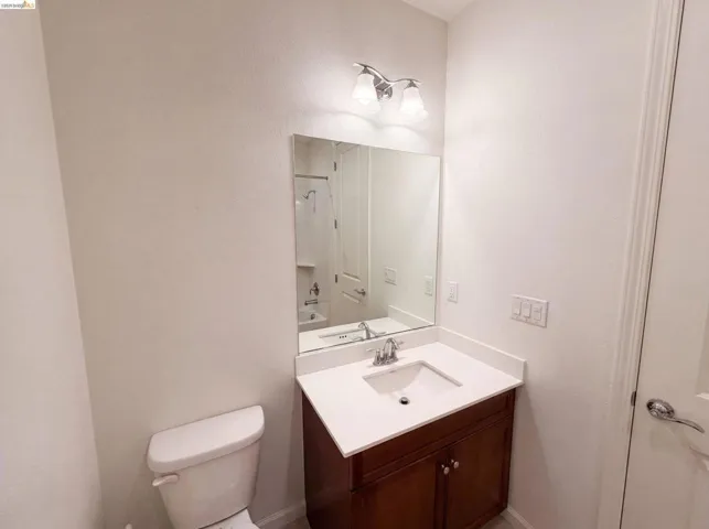 Vanity with a light-toned countertop, undermount sink, and chrome faucet