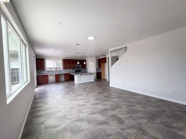 Spacious open-concept interior featuring large format floor tiling