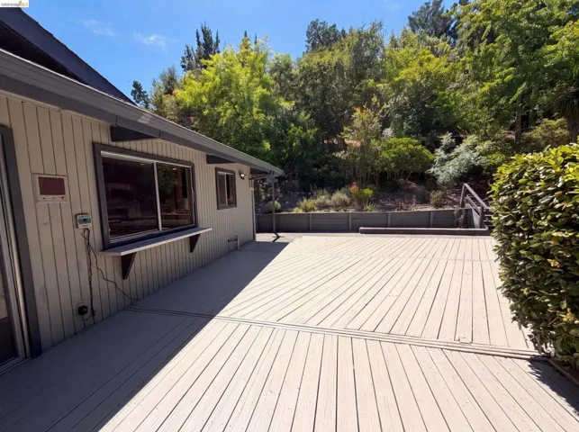 Expansive outdoor deck featuring wood-finish decking and a built-in serving counter
