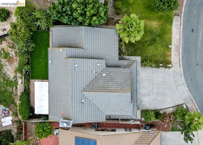 Aerial perspective showcasing a multi-gabled roofline and a concrete driveway