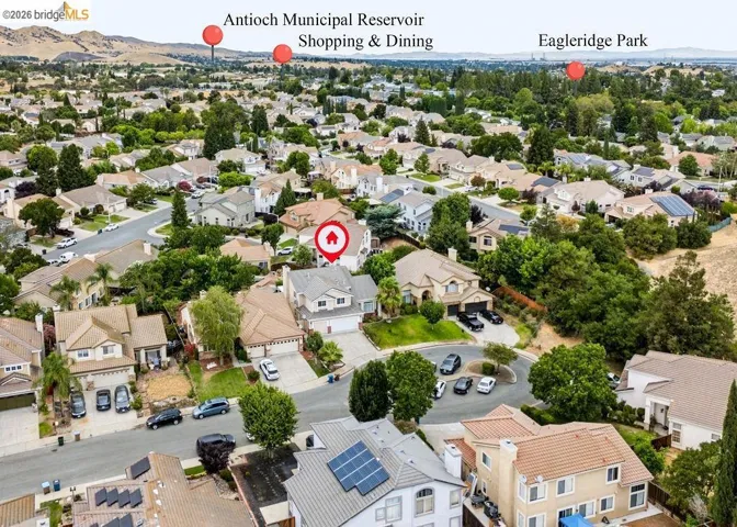 Aerial view showcasing a residential neighborhood with varied architectural styles and mature landscaping