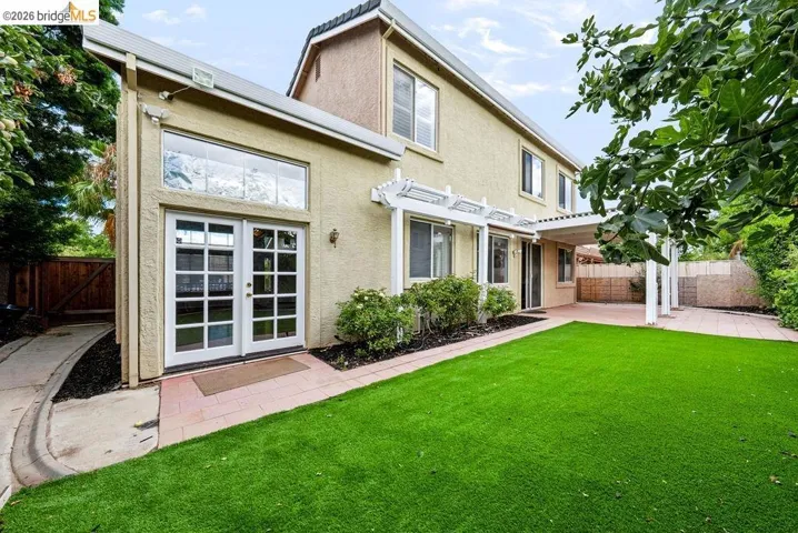 Expansive artificial turf lawn with a large paved patio