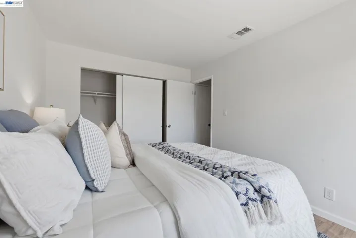 White walls and wood-finish flooring define this bright room