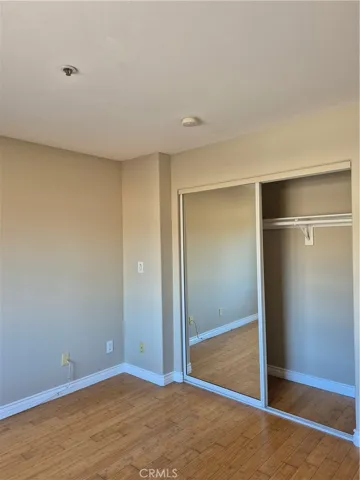 2nd bedroom with mirrored wall wardrobe