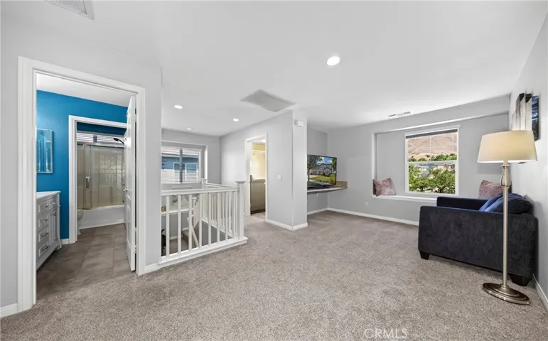 Bright landing area positioned between the stairs and the laundry room
