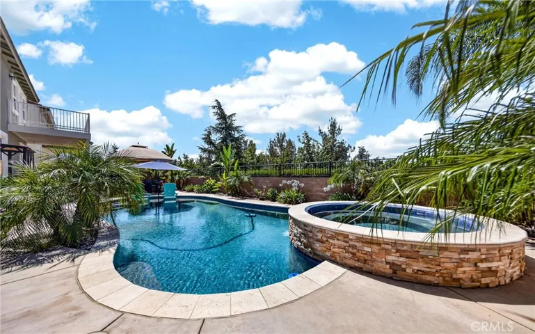Gorgeous and refreshing salt water pool and spa. This pristine outdoor oasis features a modern design, providing the perfect setting for relaxation or entertaining on warm summer days.