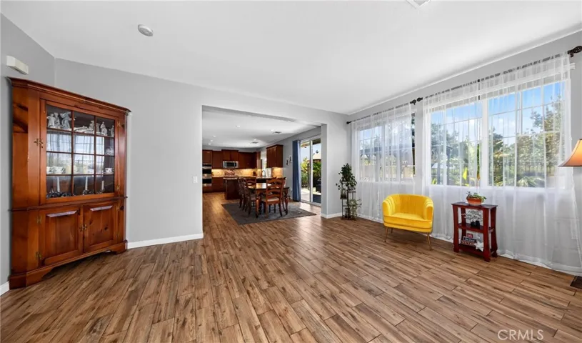Spacious open-concept living room featuring a seamless transition into the kitchen and dining area, perfect for entertaining and modern daily living.
