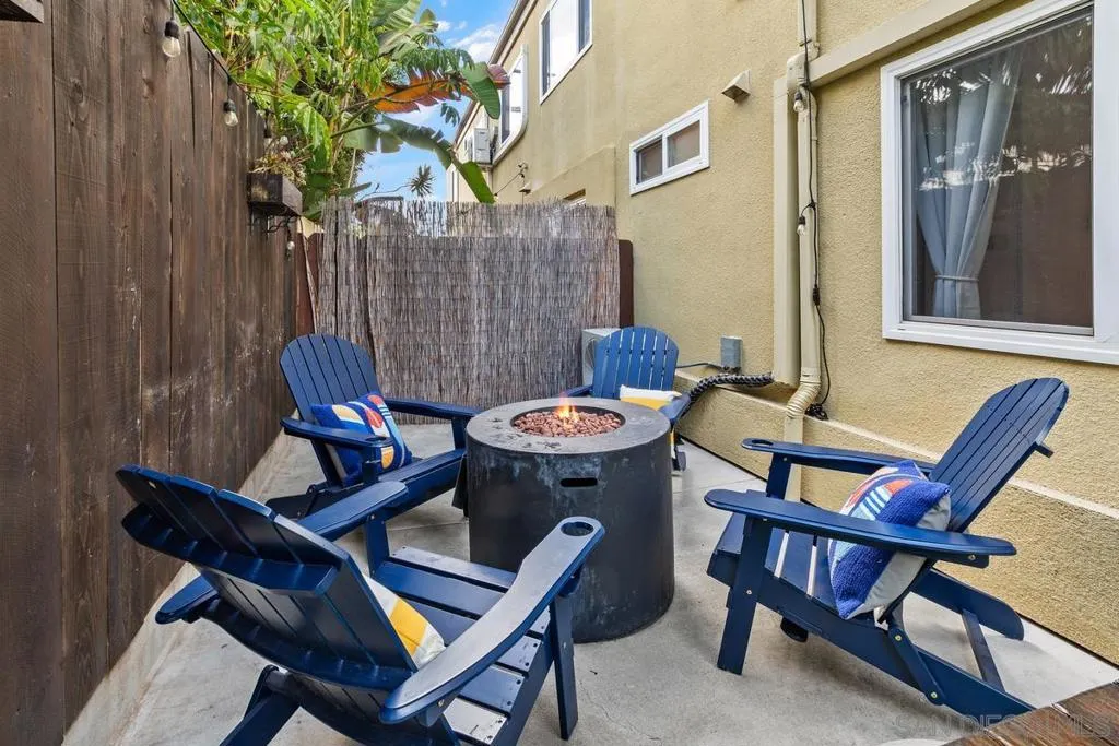 Firepit with Adirondack chairs and throw pillows and firepit - cozy on cool evenings.