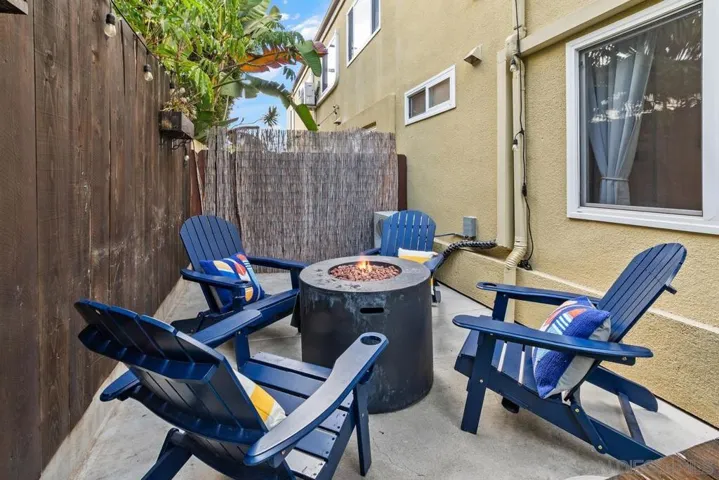 Firepit with Adirondack chairs and throw pillows and firepit - cozy on cool evenings.