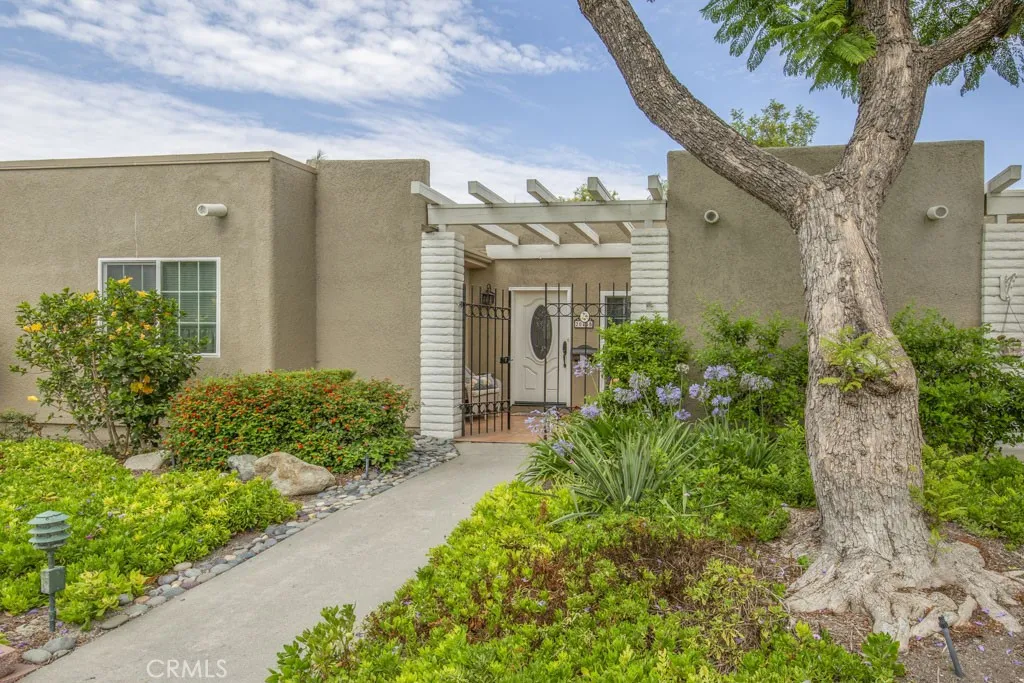 Welcome to 2044-B Via Mariposa - a gorgeous highly upgraded expanded and reconfigured single-level, two-bedroom, two-bath CORDOBA residence in the Laguna Woods senior community. The entry gate opens to a small front patio area.