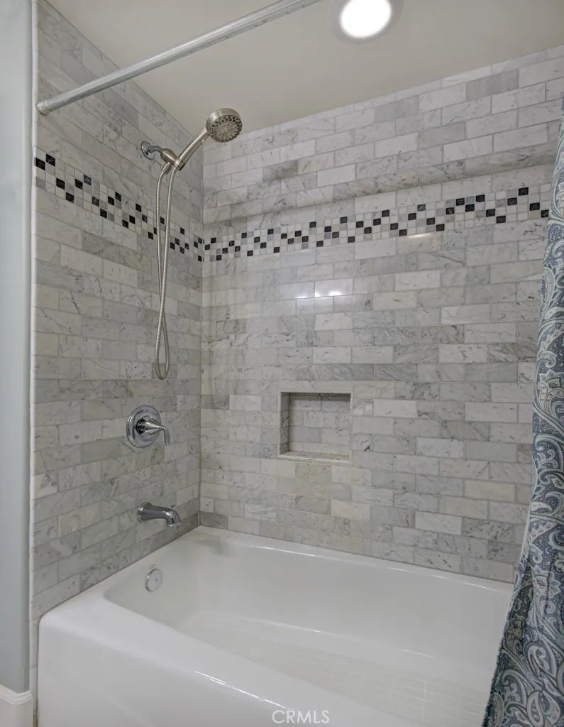 Shower-tub combo in guest bathroom.