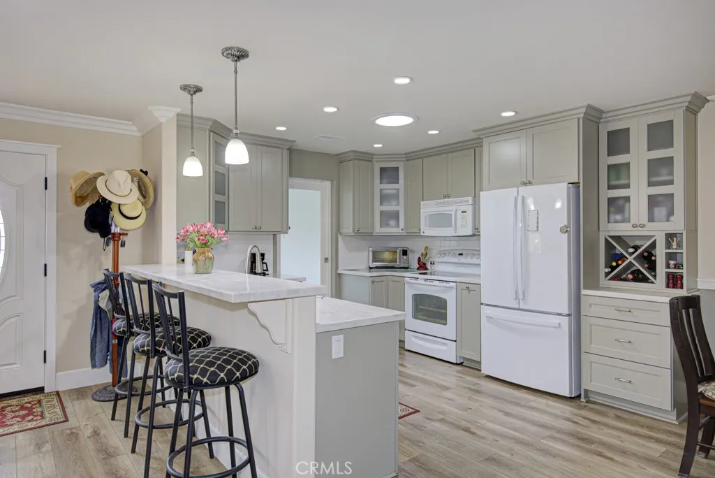 Kitchen and breakfast bar which can seat up to four. Front door can be partially seen at far left.